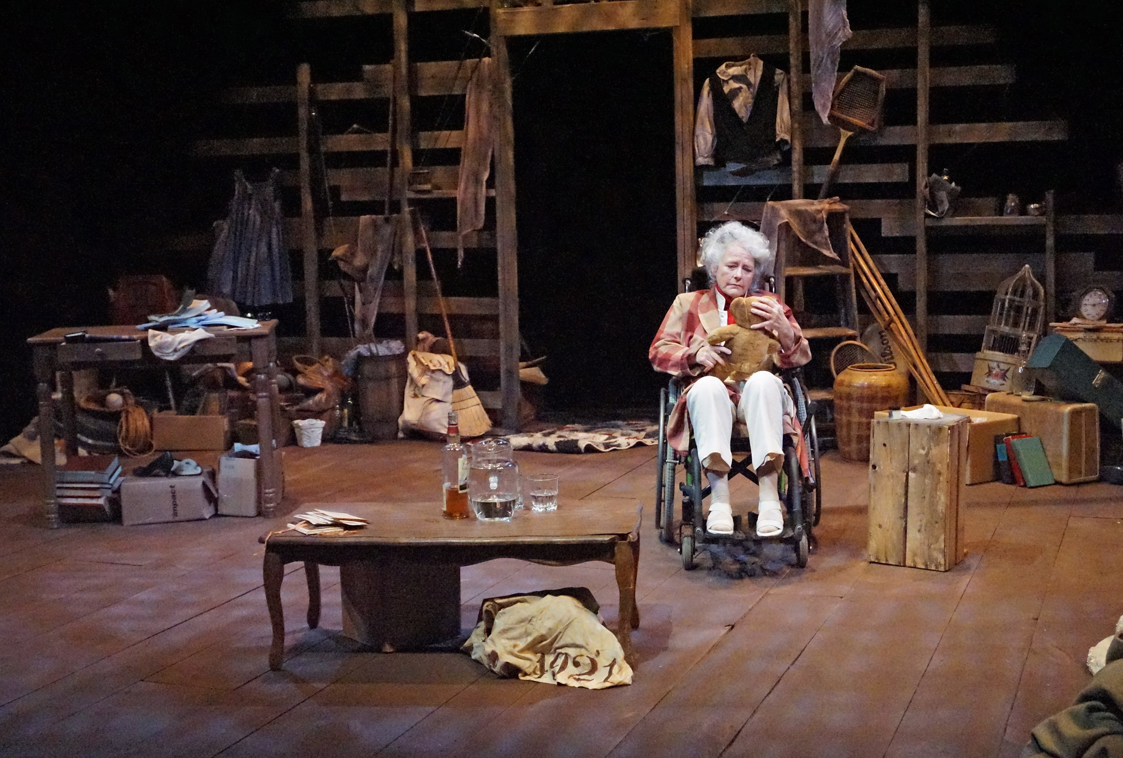 janis stephens with teddy bear as Kate Hepburn, full stage view from LNT's current production