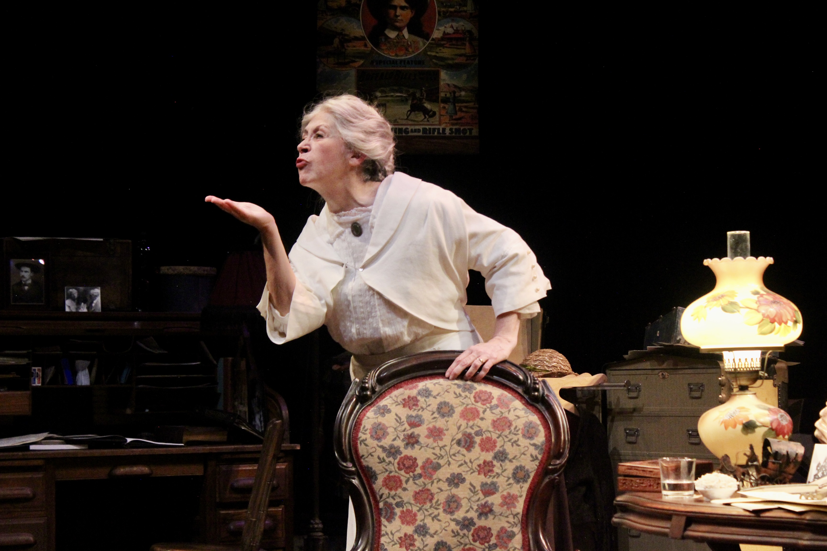 maura as annie oakley bids adieu to an unwanted suitor in Lost Nation Theater's world premiere of Both Eyes Open by Jeanne Beckwith